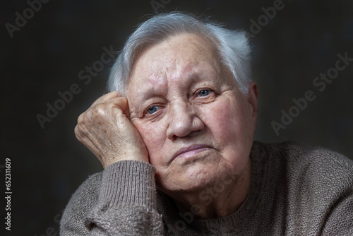Elderly woman in the studio, close-up