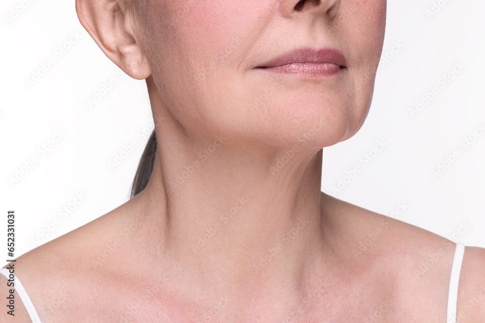 Senior woman with aging skin on white background, closeup. Rejuvenation treatment