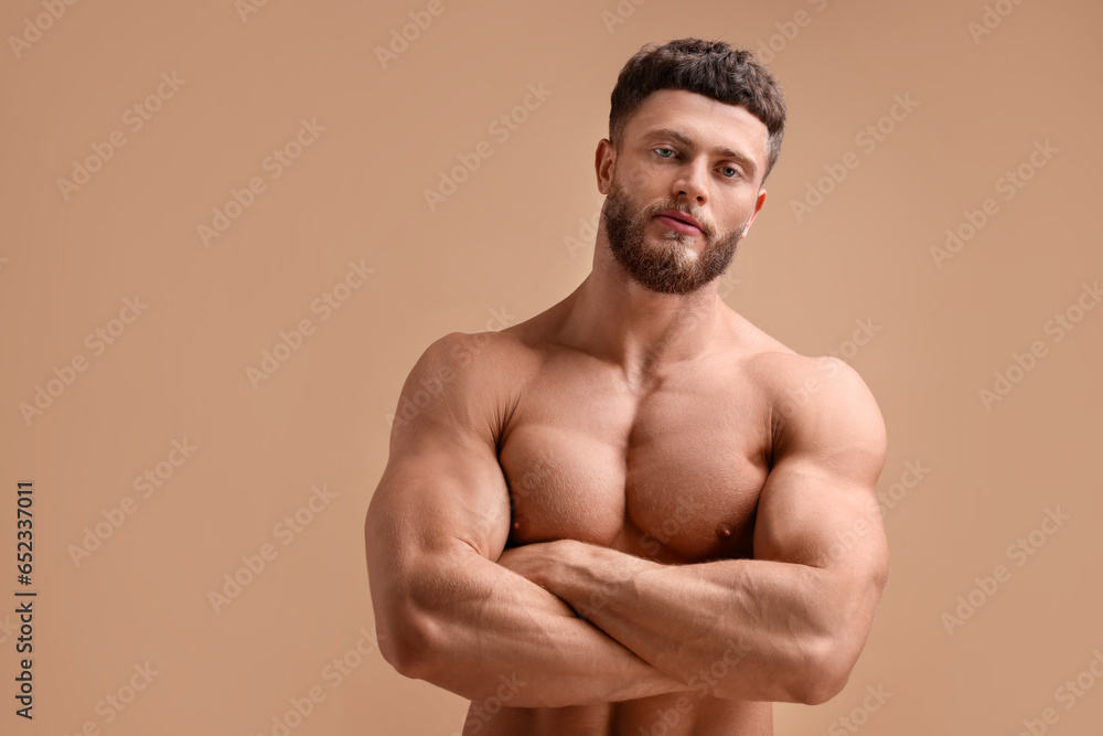 Handsome muscular man on beige background. Sexy body Handsome muscular man on beige background. Sexy body