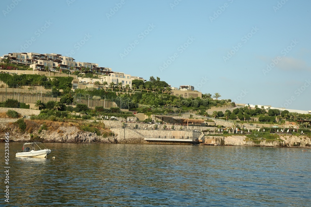 Picturesque view of sea and shore under blue sky