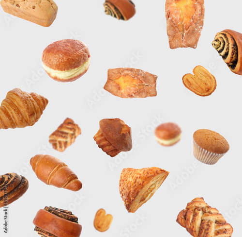 Aromatic fresh pastries falling on light grey background