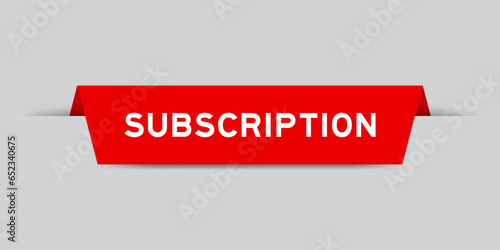 Red color inserted label with word subscription on gray background