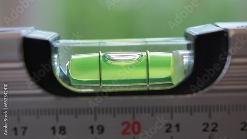 Measuring Flatness with Spirit Level Close Up Leveling Tool