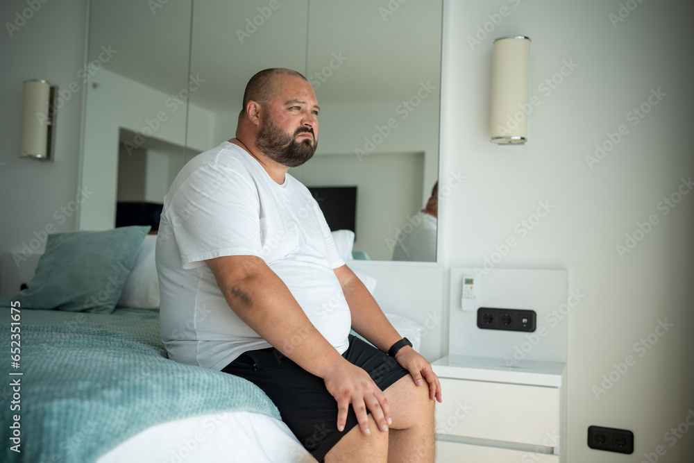 Fat Obese Guy Sitting On Bed With Disgruntled Face Overweight Man Woke 