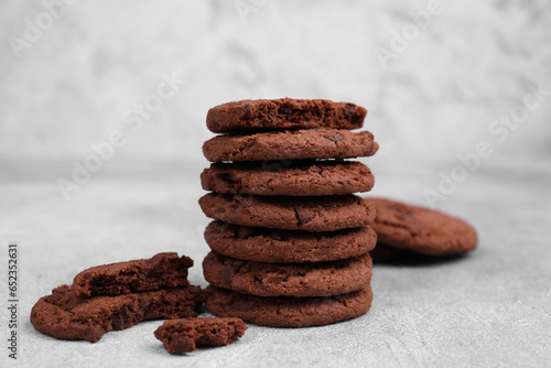 Tasty chocolate cookies on light grey table, closeup