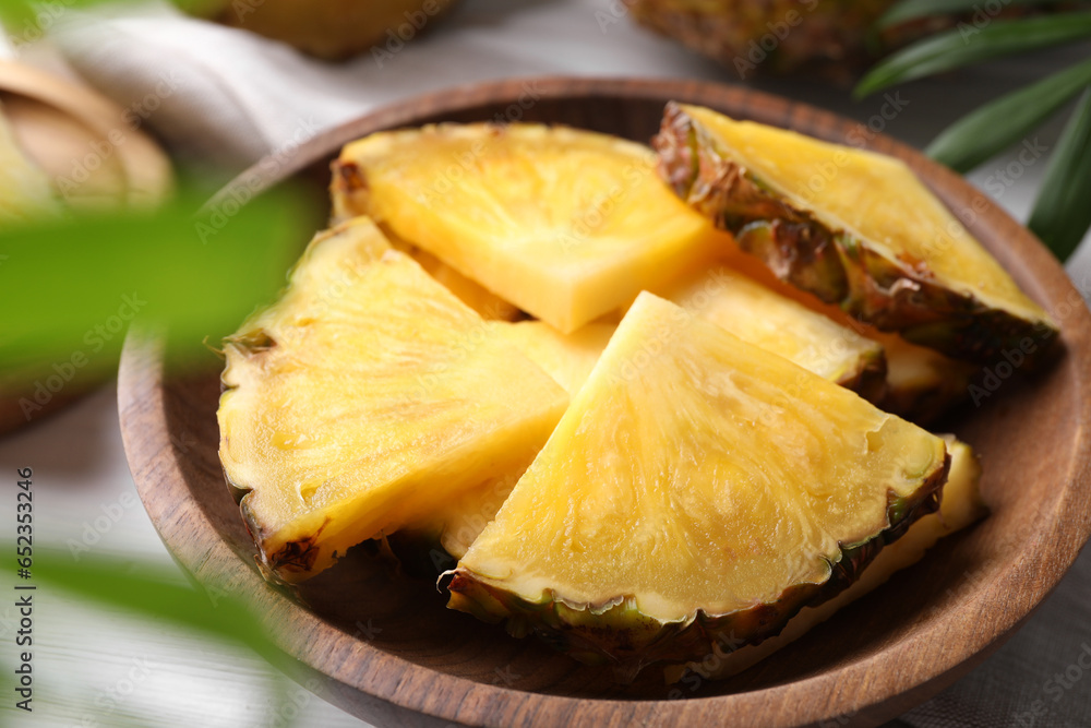 Pieces of tasty ripe pineapple in bowl on table, closeup Pieces of tasty ripe pineapple in bowl on table, closeup