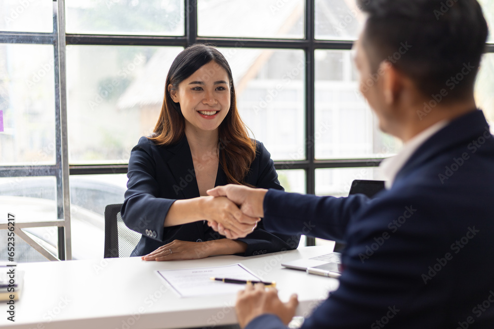Business partners and colleagues shaking hands at work cooperation. Job applicant shaking hands with executives in office room at job interview. Business partners and colleagues shaking hands at work cooperation. Job applicant shaking hands with executives in office room at job interview.