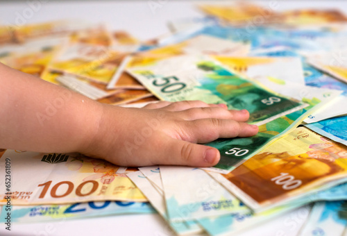 shekel  banknotes in hand children