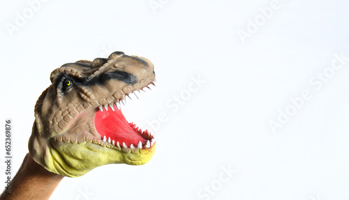 t-rex head puppet with open mouth on white background © Alvaro