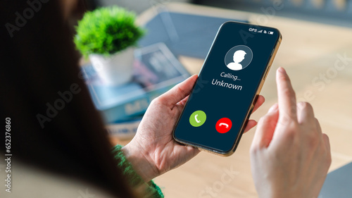 Konstfotografi Human use smartphone with incoming call from unknown number, spam, prank caller,