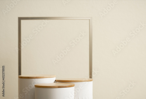 Minimal wood white podium with blurred golden frame on gold beige background.Beauty cosmetic new product modern display,luxury celebrate concept.