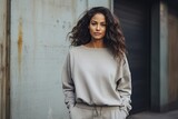 young woman wearing greay sweatpants and sweatshirt - fashion shoot (Generative AI)