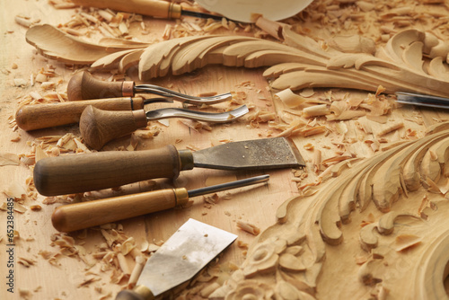 Professional tools on a wooden table in the workshop. Surface covered with sawdust. Carpenter working with tools close-up