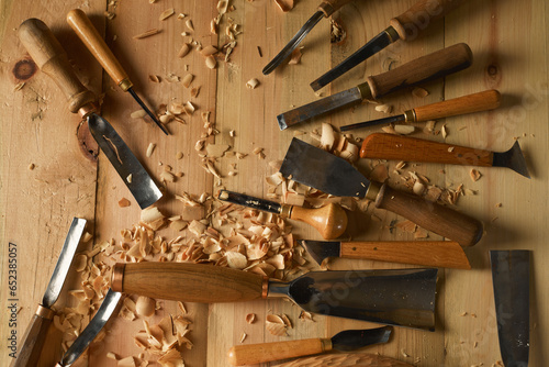 Professional tools on a wooden table in the workshop. Surface covered with sawdust. Carpenter working with tools close-up photo