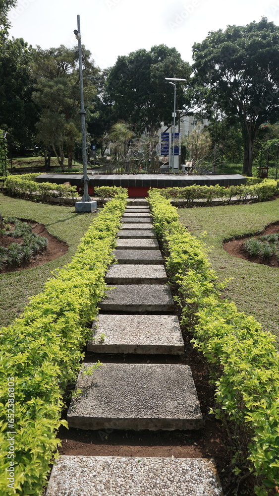 Tranquil Garden Pathway: A Serene Stroll Amidst Abundant Foliage and the Graceful Presence of a Fountain in Nature's Embrace Tranquil Garden Pathway: A Serene Stroll Amidst Abundant Foliage and the Graceful Presence of a Fountain in Nature's Embrace