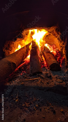 Mastering Culinary Artistry: Utilizing Burning Firewood in a Frying Stove for Delectable and Flavorful Cooking