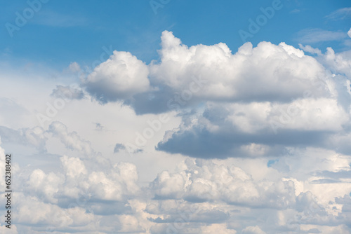 Blue sky background with many clouds. Natural aerial landscape.