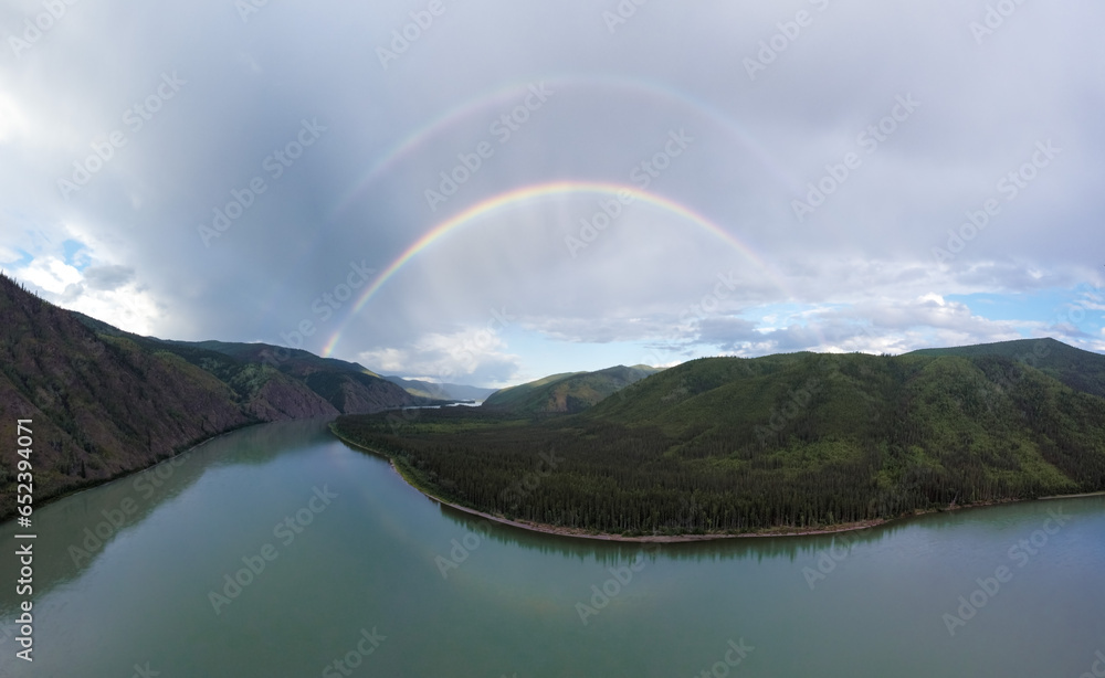 double rainbow above epic panorama view of Yukon river, off the beaten track in the wilderness of Canada double rainbow above epic panorama view of Yukon river, off the beaten track in the wilderness of Canada
