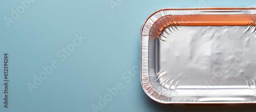 Close up of a takeaway meal in a black food box wrapped in foil isolated pastel background Copy space