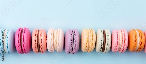 Assorted macarons against isolated pastel background Copy space