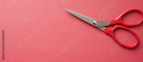 Scissors in red against iso...