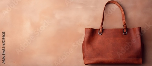 Vintage brown leather bag for elderly women kept separate isolated pastel background Copy space © vxnaghiyev