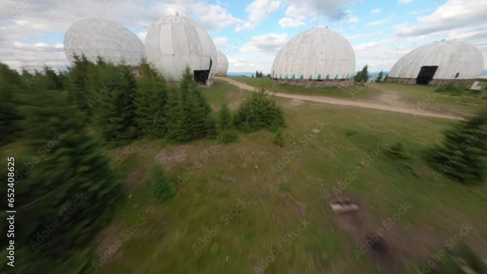 FPV, Abandoned radar station Pamir in Carpathian mountains, research station on top of the mountain in the Carpathians in Ukraine. large white balloons designs in the mountains among the fir trees FPV, Abandoned radar station Pamir in Carpathian mountains, research station on top of the mountain in the Carpathians in Ukraine. large white balloons designs in the mountains among the fir trees