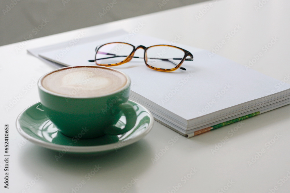 Latte art heart, green coffee cup on white table. Latte art heart, green coffee cup on white table.