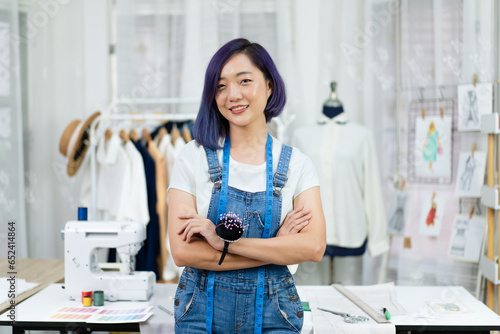 portrait of young woman fashion stylist designer standing crossed arms, professional dressmaker design clothing new collection, female freelance tailor working at home dress shop small business owner photo