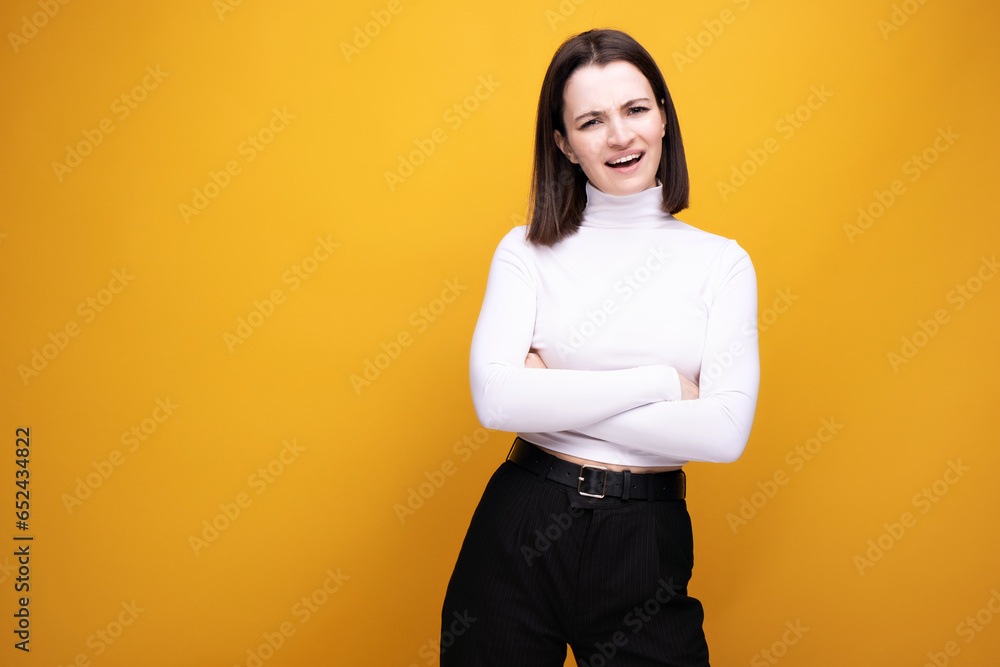 Close-up portrait of a surprised brunette on a yellow background Close-up portrait of a surprised brunette on a yellow background