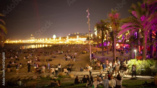 crowds on beach at night in barcelona