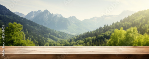 Wooden table on a beautiful blurred background of a mountain landscape with trees.