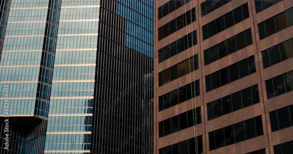 Fototapeta premium Downtown skyscraper extravaganza: breathtaking view from below focusing on towering windows of downtown. Capture the essence of downtown city life through reinforced concrete office buildings