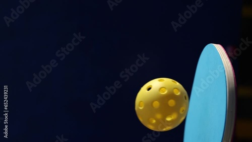 Pickle ball paddle juggling a ball in slow motion