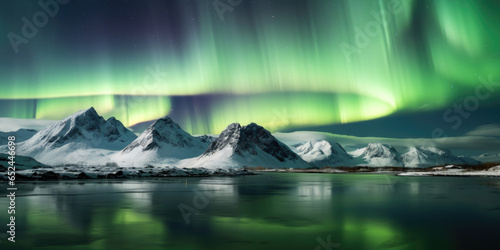 Northern lights over the lake, snow-covered mountains