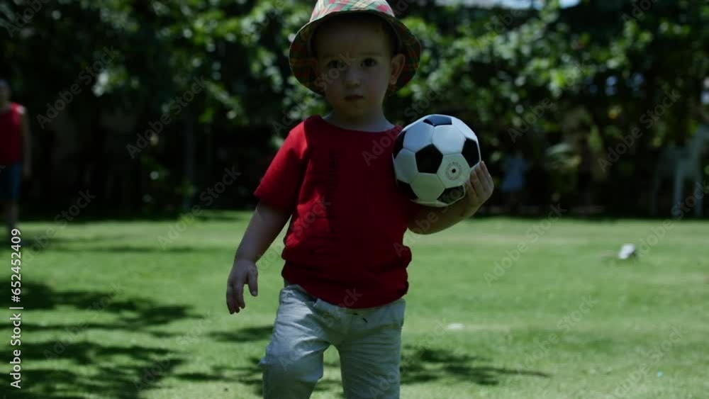 baby boy playing football soccer in the park on the grass. happy family dream kid concept. little son child play ball outdoor lifestyle sports in park healthy. kid play with son fun into ball. 4K baby boy playing football soccer in the park on the grass. happy family dream kid concept. little son child play ball outdoor lifestyle sports in park healthy. kid play with son fun into ball. 4K