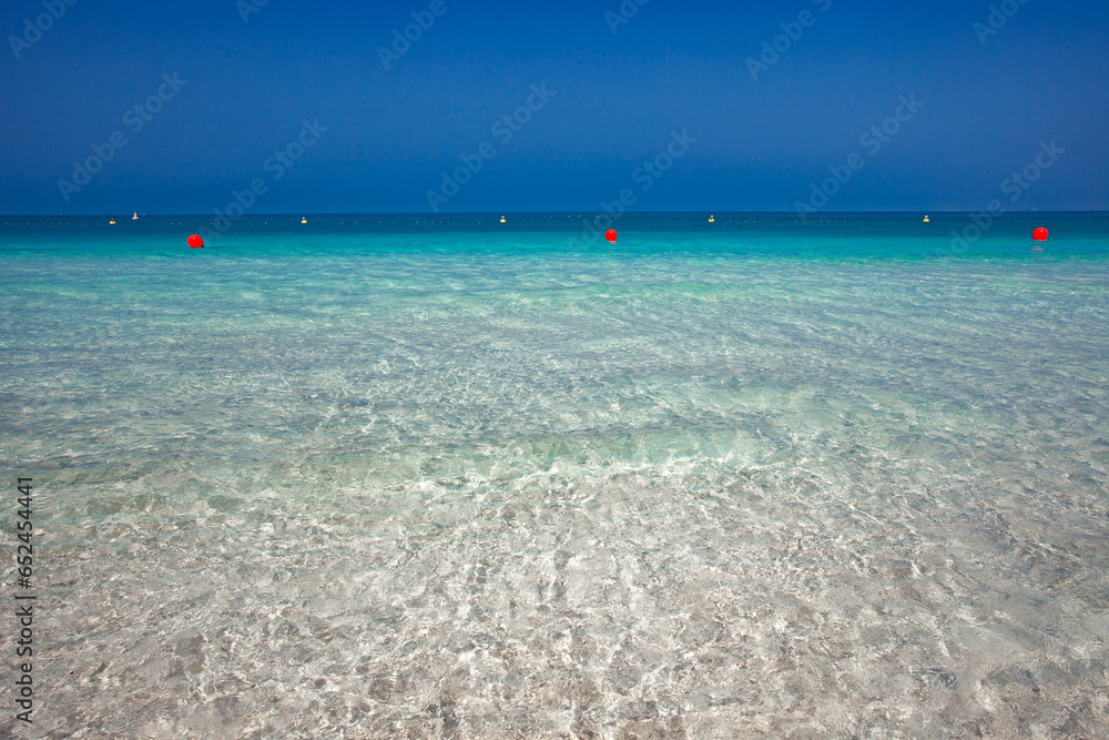 Sea with clear blue ripples water and red buoys on surface on clear sunny day Sea with clear blue ripples water and red buoys on surface on clear sunny day