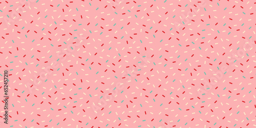Seamless pattern with decorative bright sprinkles texture on pink background.