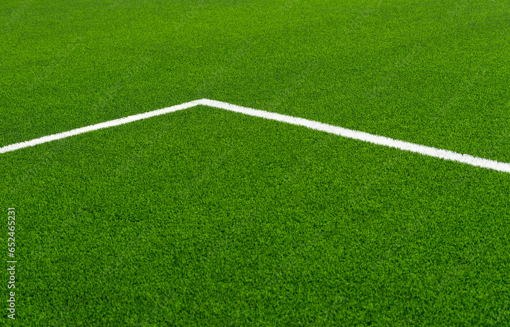 Green synthetic grass sports field with white line shot from above. Soccer, hurling, lacrosse, rugby, football, baseball sport concept