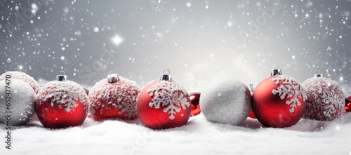 A festive display of red and white ornaments in a snowy landscape