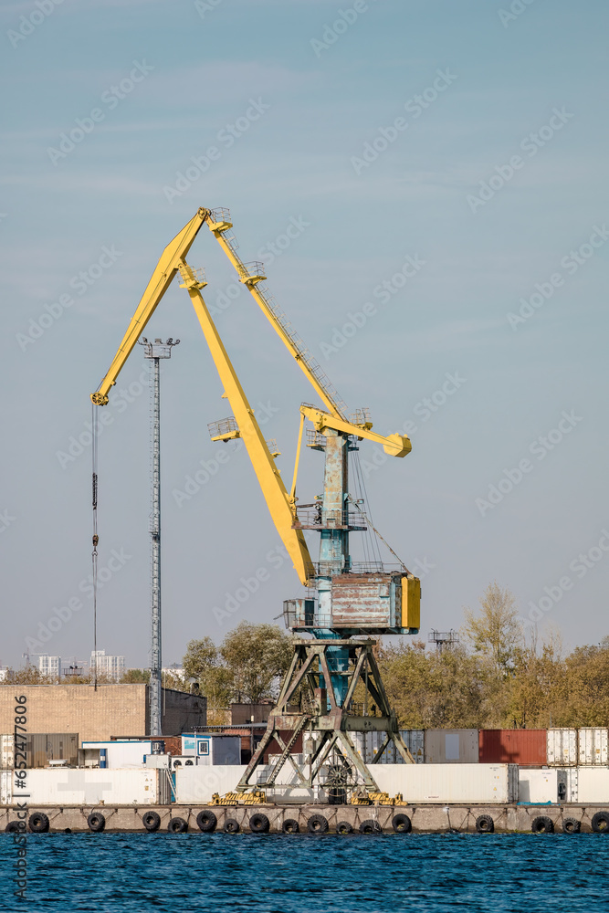 Yellow port crane and containers for freight on ship Yellow port crane and containers for freight on ship