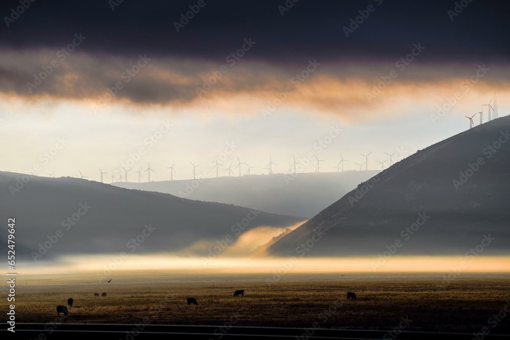 Foggy Mountain Wind Turbines at Dawn: Spectacular Yellow Sunset in 4K