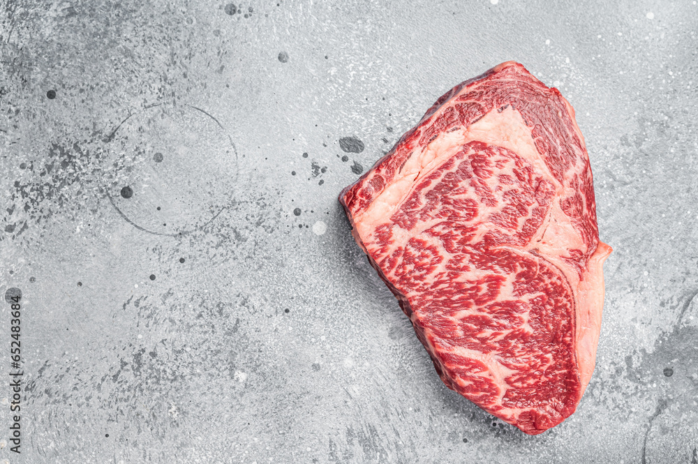 Japanese wagyu rib eye beef meat steak. Gray background. Top view. Copy space