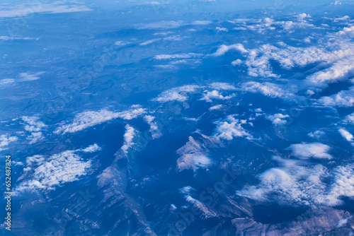 Mountain peaks seen through the clouds from the plane