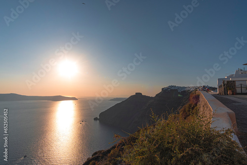 Beautiful sunset landscape in coastal cliff rock island in Santorini, Greece photo