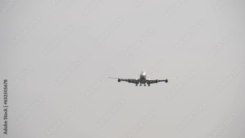 Widebody aircraft landing approach, long shot. Four-engine airplane in the sky Widebody aircraft landing approach, long shot. Four-engine airplane in the sky