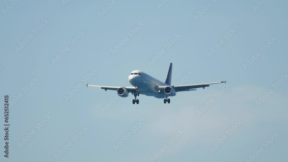 Jet airplane landing at Phuket airport, side view. Aircraft approaching. Tourism travel concept Jet airplane landing at Phuket airport, side view. Aircraft approaching. Tourism travel concept