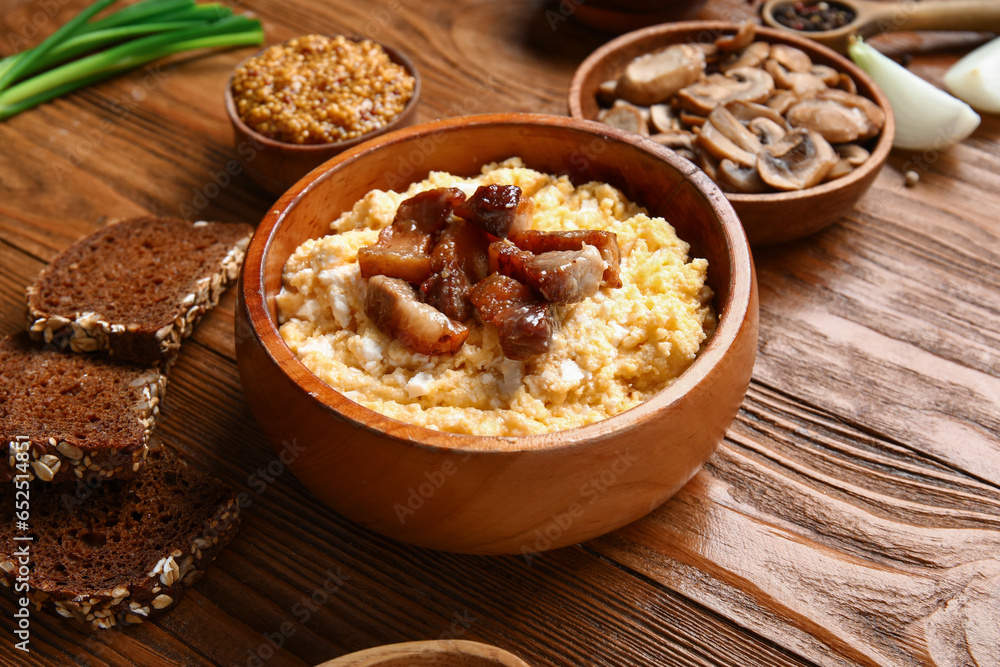 Bowl of tasty banosh on wooden background Bowl of tasty banosh on wooden background