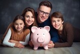 happy family sitting on the floor around the piggy bank