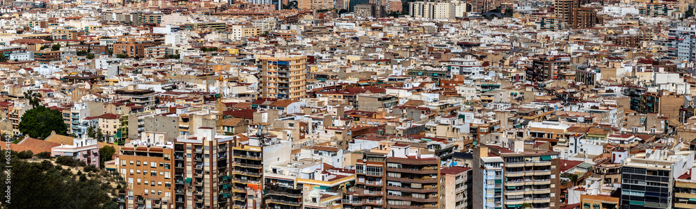 Cityscape of Alicante in summer, Spain. Large panorama of old city. Towers and roofs of the city tiled roofs high resolution panorama of roofs of old city for design print with